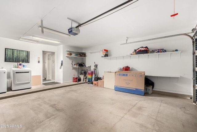 garage with washer and clothes dryer and a garage door opener