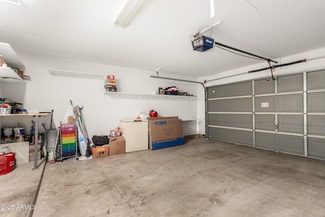 garage with refrigerator and a garage door opener