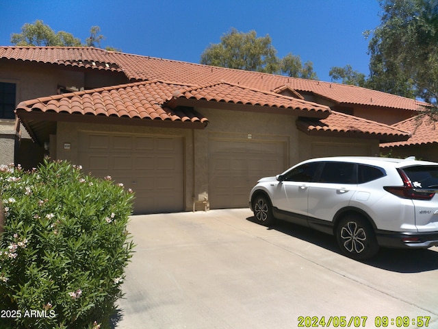 8700 E Mountain View Rd Unit 2029, Scottsdale, AZ 85258 - view of front of house with an attached garage, driveway, stucco siding, and a tile roof