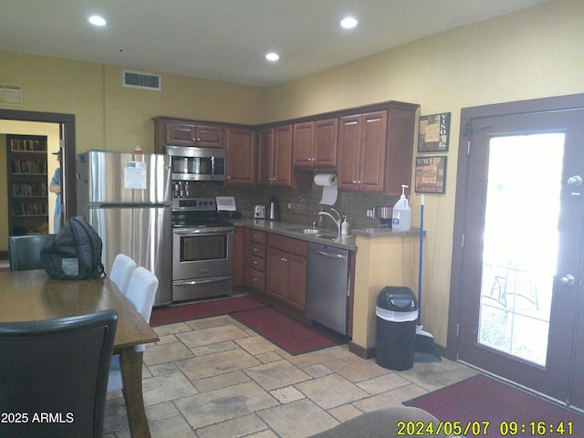 8700 E Mountain View Rd Unit 2029, Scottsdale, AZ 85258 - kitchen with stainless steel appliances, a sink, decorative backsplash, recessed lighting, and stone tile flooring