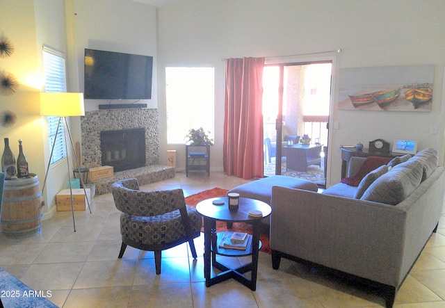8700 E Mountain View Rd Unit 2029, Scottsdale, AZ 85258 - living room with light tile patterned flooring, a stone fireplace, and healthy amount of natural light