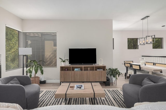 7887 N 16th St Unit 224, Phoenix, AZ 85020 - living room with a chandelier, wood finished floors, and plenty of natural light