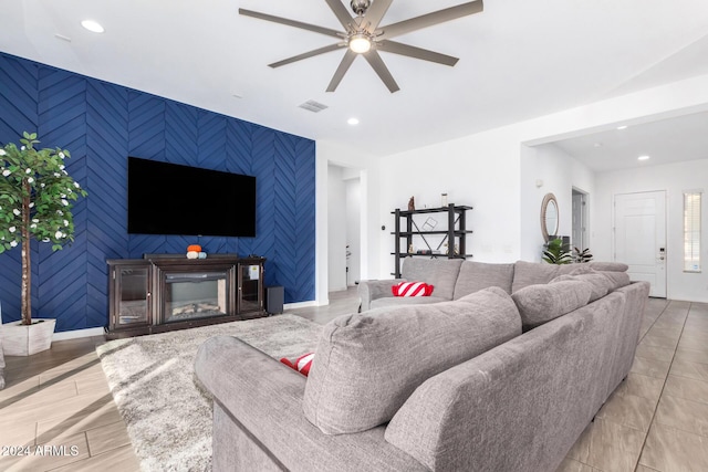 living room featuring light hardwood / wood-style flooring and ceiling fan