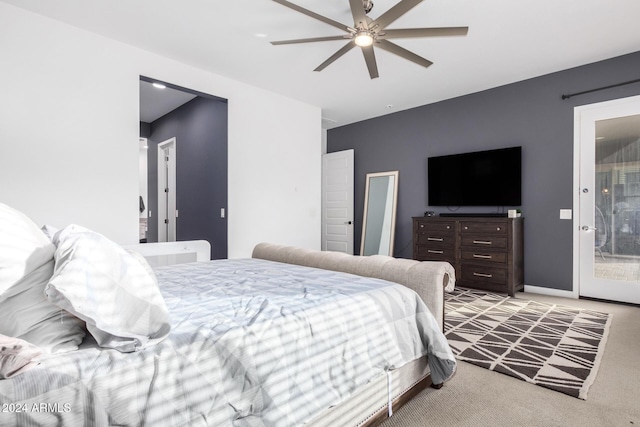 bedroom with ceiling fan, light colored carpet, and connected bathroom