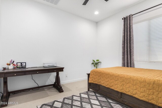 bedroom with light carpet and ceiling fan