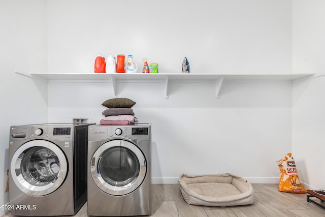 laundry area with independent washer and dryer and hardwood / wood-style flooring