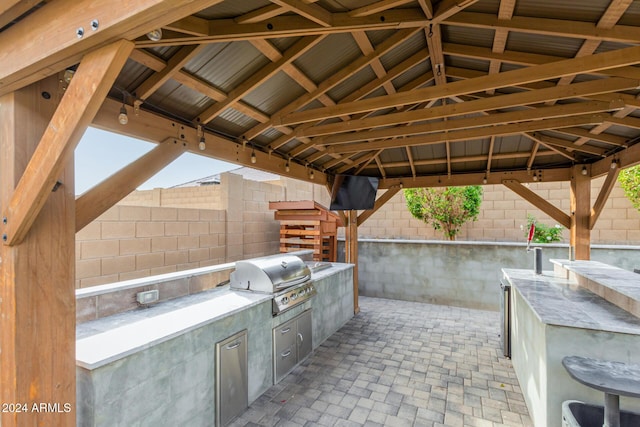 view of patio featuring a gazebo, a grill, and an outdoor kitchen