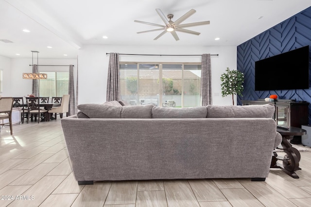 living room with light wood-type flooring and ceiling fan