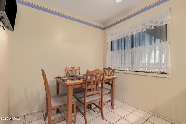 dining space featuring light tile patterned floors