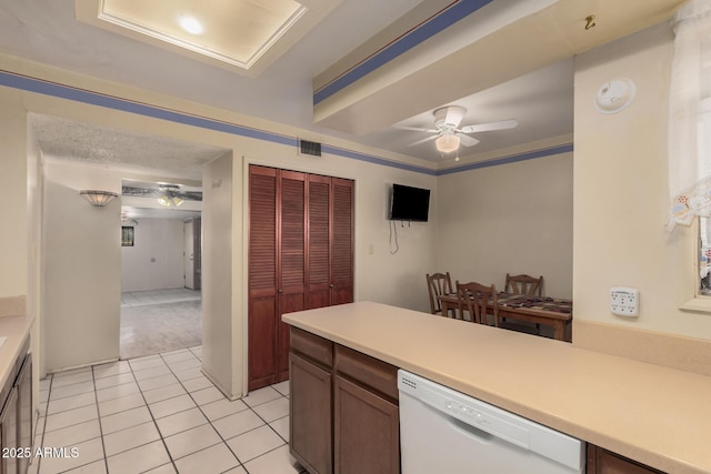 kitchen with ceiling fan, white dishwasher, light tile patterned flooring, and ornamental molding