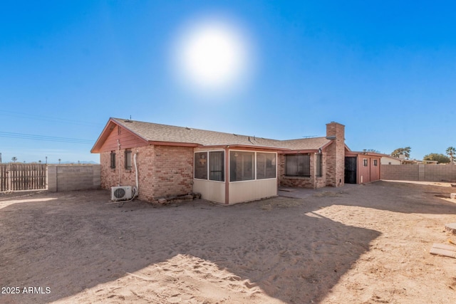 rear view of property with ac unit