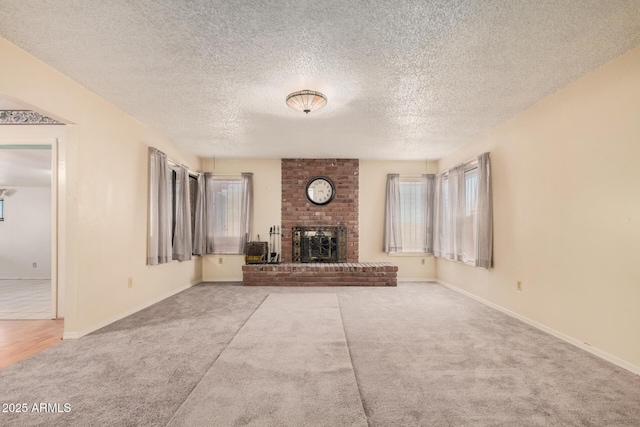 unfurnished living room featuring a textured ceiling, carpet floors, and a fireplace