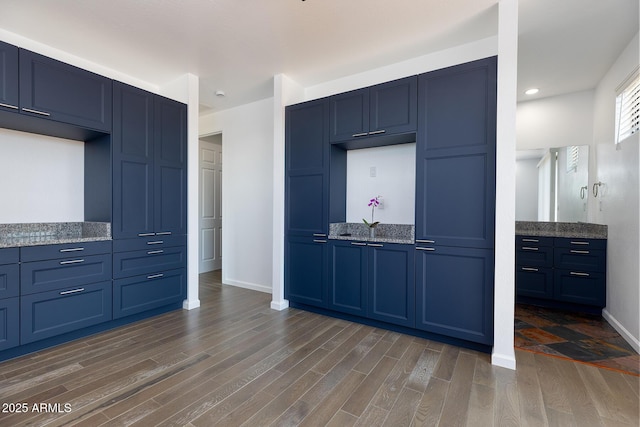 2943 E Lookout Ln, Overgaard, AZ 85933 - kitchen featuring blue cabinetry, dark wood-style floors, light stone countertops, baseboards, and recessed lighting