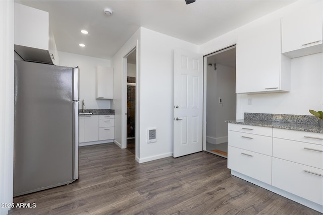 2943 E Lookout Ln, Overgaard, AZ 85933 - kitchen with freestanding refrigerator, white cabinetry, dark wood-style floors, and recessed lighting