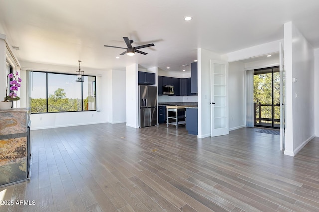 2943 E Lookout Ln, Overgaard, AZ 85933 - unfurnished living room featuring a ceiling fan, baseboards, dark wood finished floors, and recessed lighting