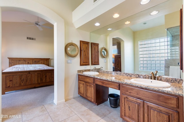 bathroom with tile patterned flooring, vanity, and ceiling fan