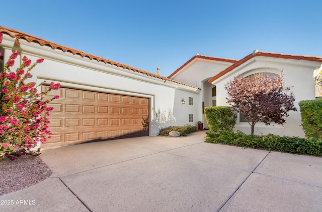 mediterranean / spanish-style home featuring a garage