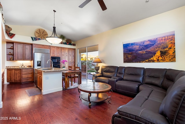 living room featuring ceiling fan, dark hardwood / wood-style flooring, lofted ceiling, and sink