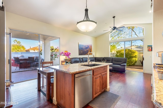 kitchen with dishwasher, a center island with sink, sink, light stone counters, and dark hardwood / wood-style flooring