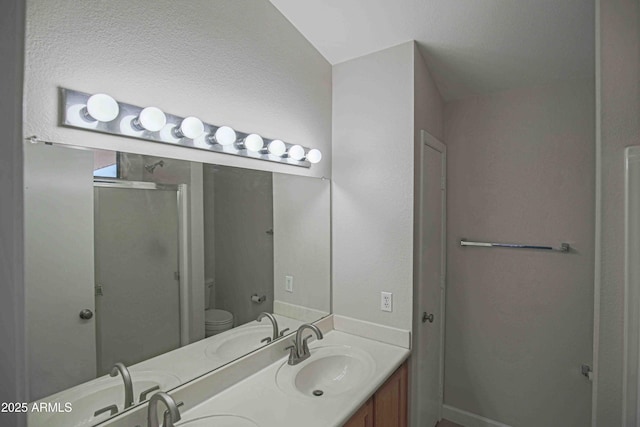 bathroom with vanity, toilet, and an enclosed shower