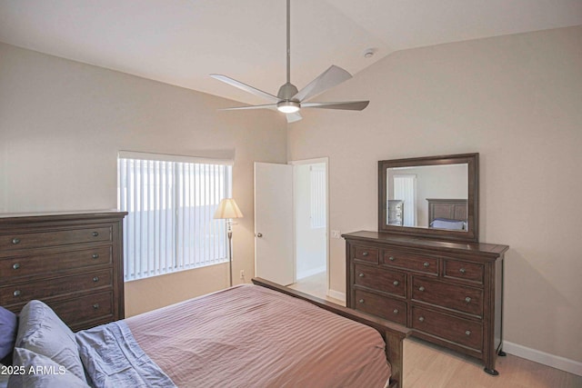 bedroom with ceiling fan, light hardwood / wood-style floors, and lofted ceiling