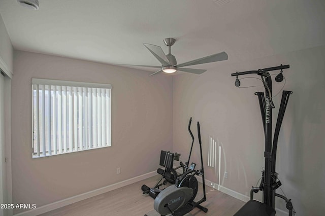 exercise area with light wood-type flooring and ceiling fan