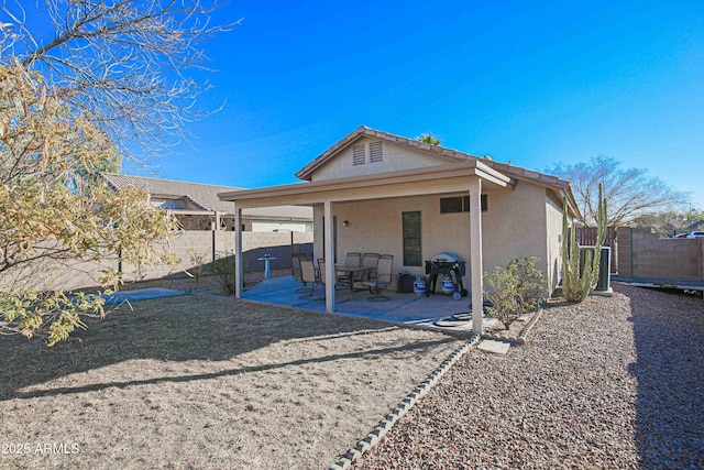 back of house with a patio