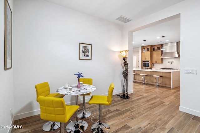 dining space with visible vents, recessed lighting, baseboards, and light wood finished floors