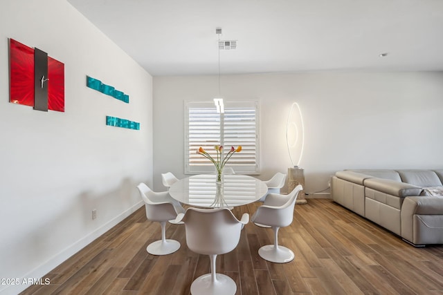 dining room with baseboards, wood finished floors, and visible vents