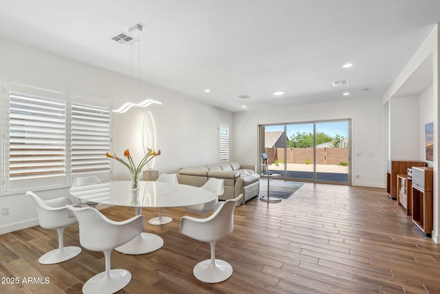 dining space featuring visible vents, recessed lighting, baseboards, and wood finished floors