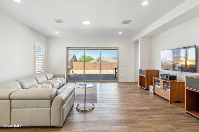 living area featuring recessed lighting, wood finished floors, and visible vents