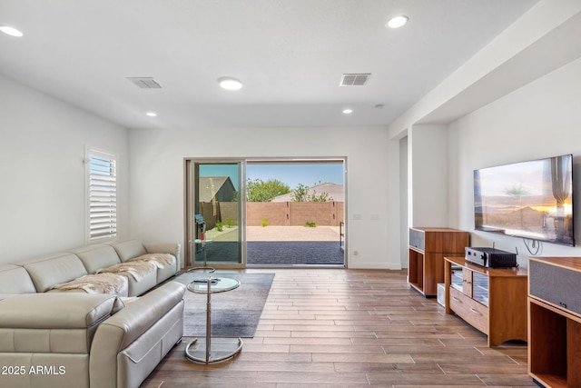 living area featuring visible vents, recessed lighting, baseboards, and dark wood-style floors