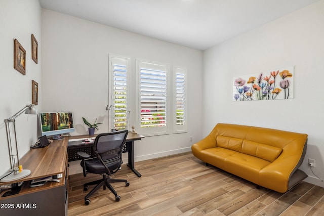home office featuring baseboards and wood finished floors