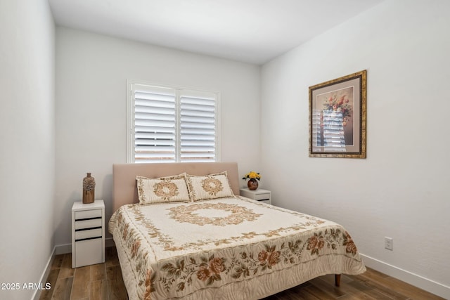 bedroom featuring baseboards and wood finished floors