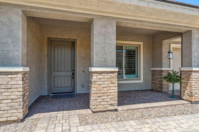 doorway to property with stucco siding