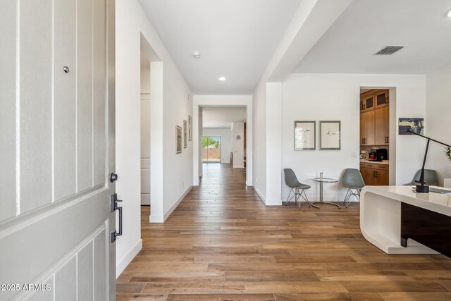 entrance foyer featuring baseboards, recessed lighting, light wood-style flooring, and visible vents