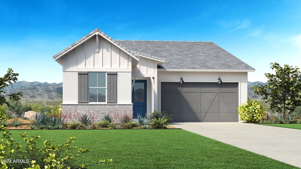 view of front of property with a garage, a mountain view, and a front yard