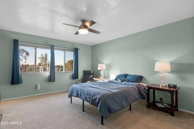 carpeted bedroom with ceiling fan and a textured ceiling