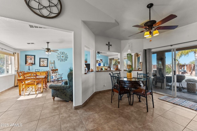 dining space with ceiling fan and tile patterned floors