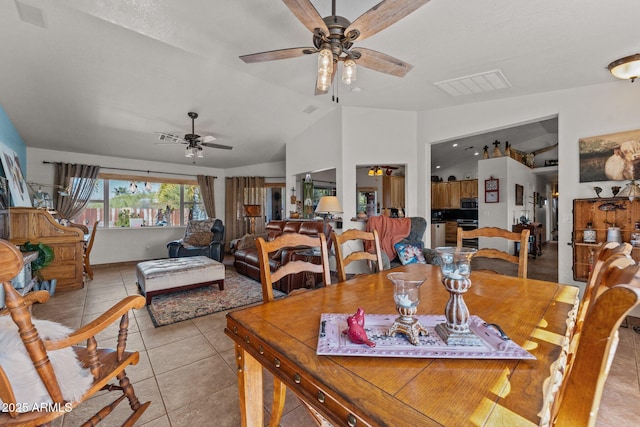 dining area with lofted ceiling, ceiling fan, and light tile patterned flooring