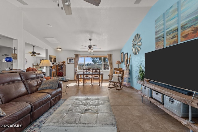 tiled living room featuring vaulted ceiling and ceiling fan