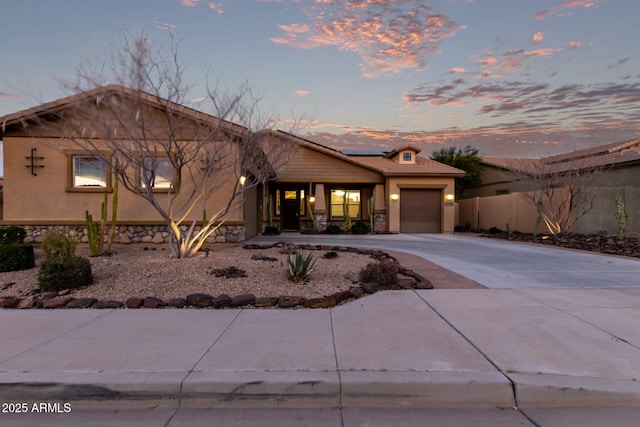 view of front of house featuring solar panels and a garage