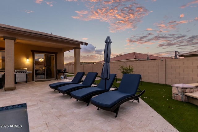 patio terrace at dusk with a grill