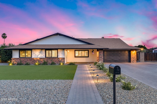 9005 W Villa Chula St, Peoria, AZ 85383 - view of front of home with an attached garage, driveway, and brick siding