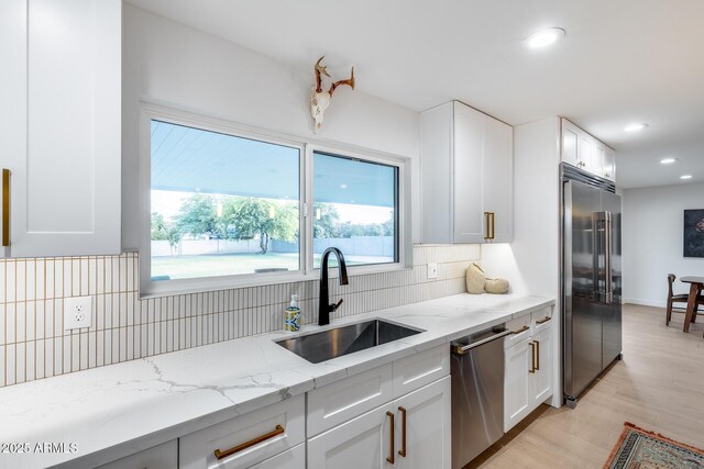 9005 W Villa Chula St, Peoria, AZ 85383 - kitchen with appliances with stainless steel finishes, a sink, backsplash, recessed lighting, and white cabinets