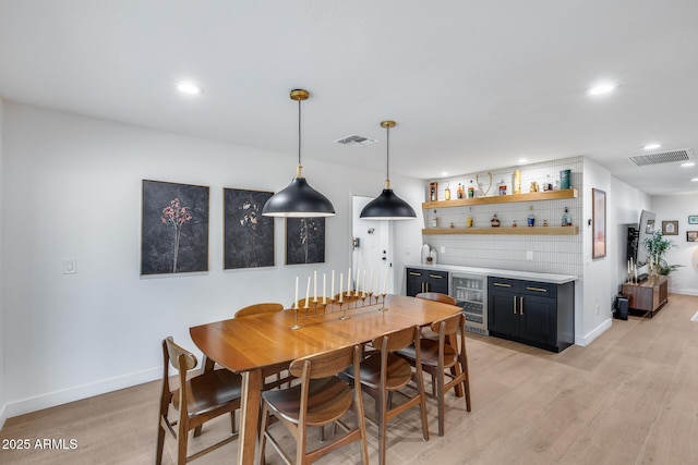 9005 W Villa Chula St, Peoria, AZ 85383 - dining area featuring beverage cooler, a dry bar, light wood finished floors, recessed lighting, and baseboards