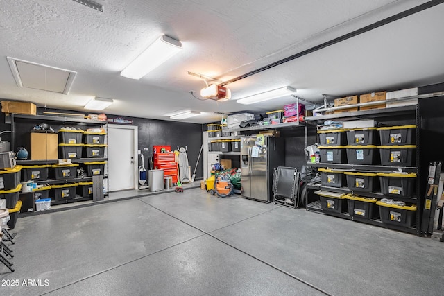 9005 W Villa Chula St, Peoria, AZ 85383 - garage with stainless steel refrigerator with ice dispenser and a garage door opener