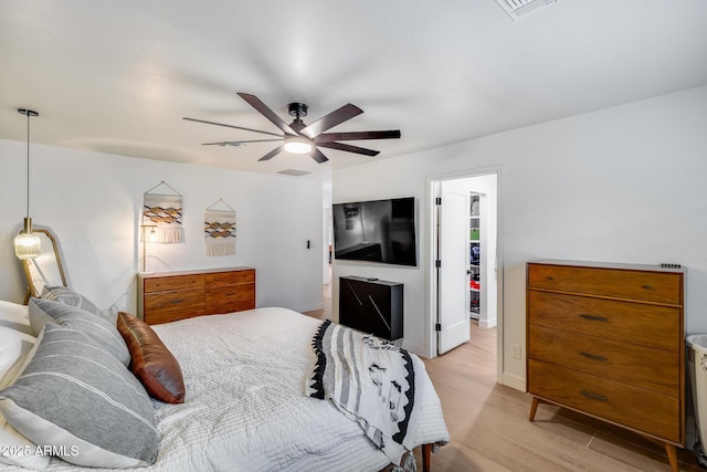 9005 W Villa Chula St, Peoria, AZ 85383 - bedroom with light wood-style floors, a spacious closet, a ceiling fan, a closet, and baseboards