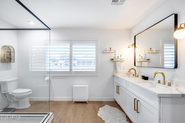 9005 W Villa Chula St, Peoria, AZ 85383 - bathroom featuring wood finished floors, toilet, double vanity, and baseboards