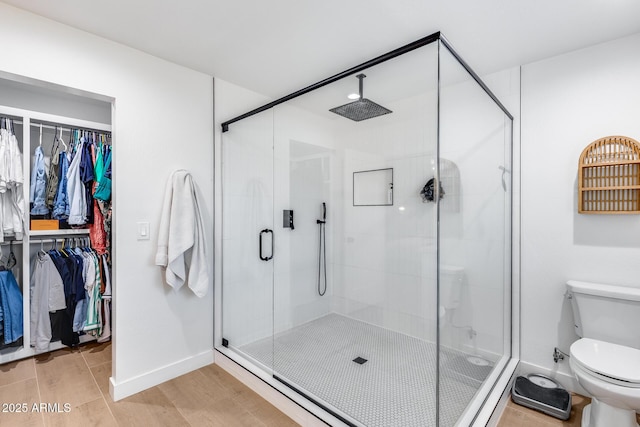 9005 W Villa Chula St, Peoria, AZ 85383 - bathroom with toilet, a stall shower, a walk in closet, and baseboards
